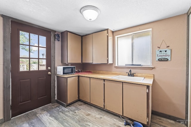 19550 Whitecap Ct, Wilder, ID 83676 - kitchen with a sink, light countertops, light wood-style flooring, and a textured ceiling