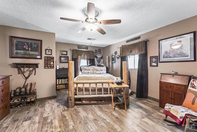 19550 Whitecap Ct, Wilder, ID 83676 - bedroom with a textured ceiling, wood finished floors, baseboards, and a ceiling fan