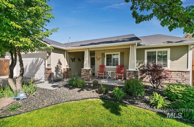 1207 Empire Ct, Caldwell, ID 83607 - view of front facade featuring covered porch, stone siding, an attached garage, and roof with shingles