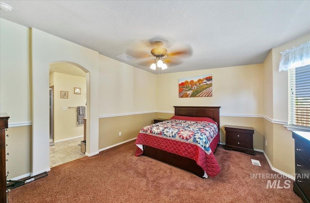1207 Empire Ct, Caldwell, ID 83607 - carpeted bedroom with arched walkways, baseboards, ceiling fan, and a textured ceiling