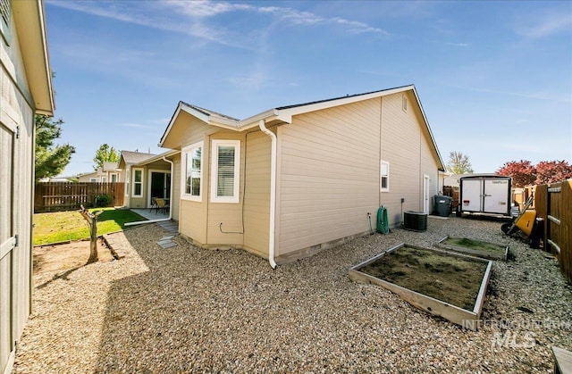 1207 Empire Ct, Caldwell, ID 83607 - view of property exterior with a storage shed, a fenced backyard, an outbuilding, crawl space, and a vegetable garden