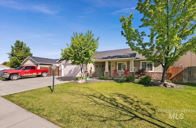 1207 Empire Ct, Caldwell, ID 83607 - single story home featuring a garage, concrete driveway, a porch, and stone siding