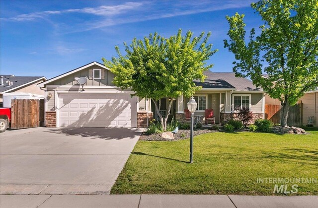 1207 Empire Ct, Caldwell, ID 83607 - view of front of home with stone siding, an attached garage, concrete driveway, and board and batten siding