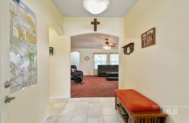 1207 Empire Ct, Caldwell, ID 83607 - hall with arched walkways, light carpet, and light tile patterned floors