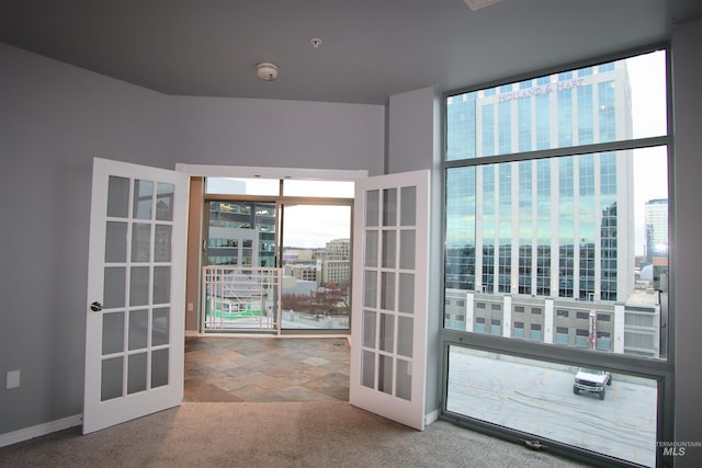 entryway featuring french doors and carpet floors