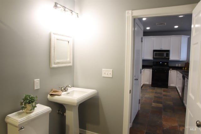 bathroom featuring toilet and sink