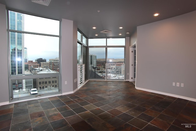 unfurnished room with floor to ceiling windows