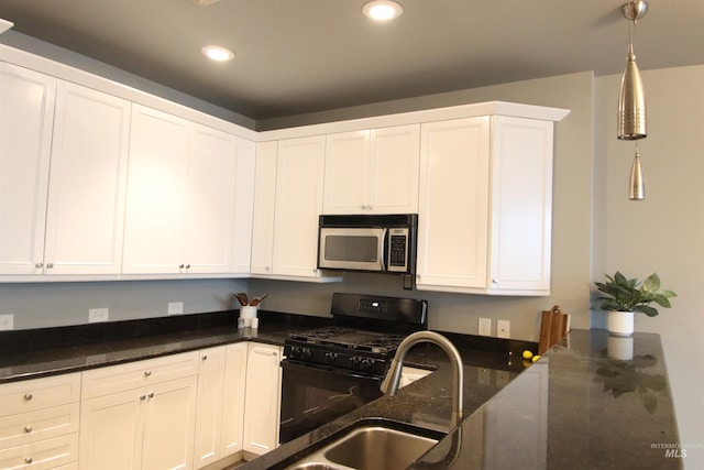 kitchen with dark stone countertops, white cabinetry, black range with gas stovetop, and decorative light fixtures