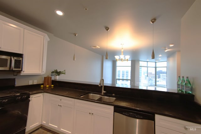 kitchen with dark stone counters, sink, decorative light fixtures, white cabinetry, and stainless steel appliances