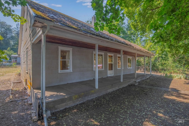 view of side of property featuring covered porch