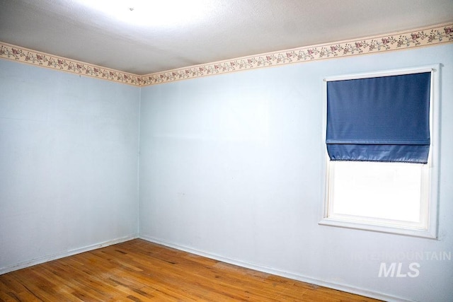 1114 12th Ave, Lewiston, ID 83501 - unfurnished room featuring wood finished floors and baseboards