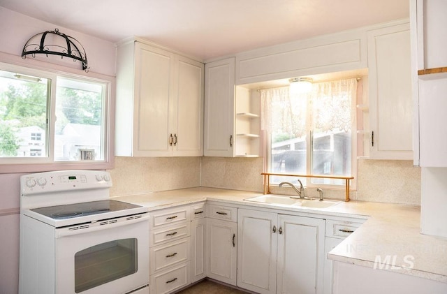 1114 12th Ave, Lewiston, ID 83501 - kitchen with electric range, a sink, decorative backsplash, and light countertops