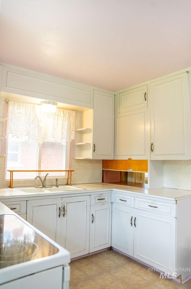 1114 12th Ave, Lewiston, ID 83501 - kitchen featuring light countertops, open shelves, a sink, and white cabinetry