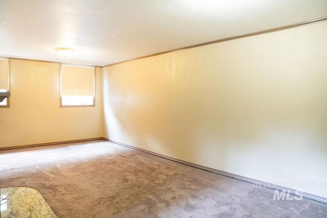 1114 12th Ave, Lewiston, ID 83501 - empty room featuring light colored carpet, baseboards, and crown molding