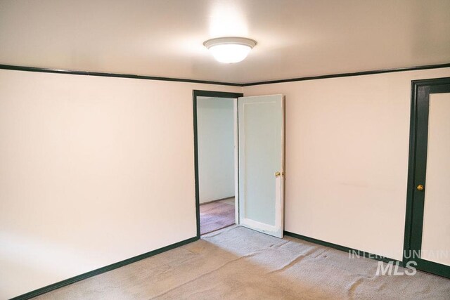1114 12th Ave, Lewiston, ID 83501 - unfurnished bedroom with light colored carpet and baseboards