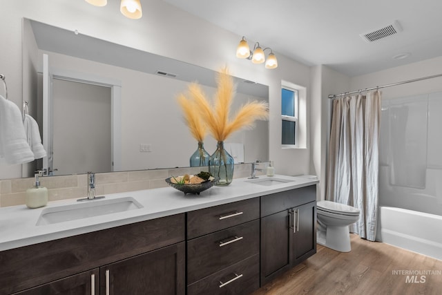11287 Shadow Glen Dr, Caldwell, ID 83605 - bathroom featuring double vanity, wood finished floors, and shower / tub combo
