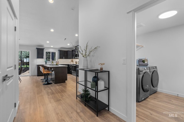 11287 Shadow Glen Dr, Caldwell, ID 83605 - washroom with washer and dryer, light wood-style floors, and recessed lighting