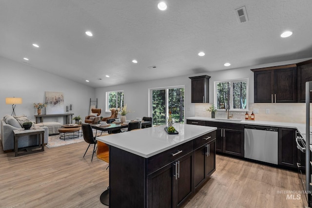11287 Shadow Glen Dr, Caldwell, ID 83605 - kitchen featuring dishwasher, recessed lighting, light wood-style flooring, open floor plan, and backsplash