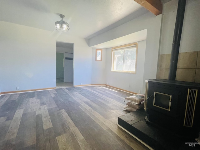720 W 1st, Fairfield, ID 83327 - unfurnished living room with a wood stove, wood finished floors, and baseboards