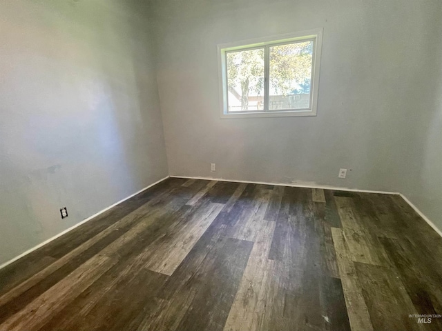 720 W 1st, Fairfield, ID 83327 - unfurnished room with dark wood finished floors and baseboards