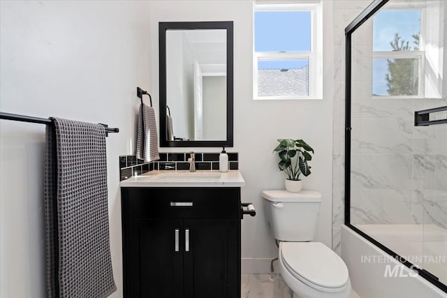 bathroom featuring baseboards, toilet, vanity, marble finish floor, and a shower with door