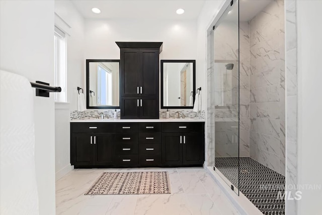 bathroom with a marble finish shower, double vanity, marble finish floor, and recessed lighting