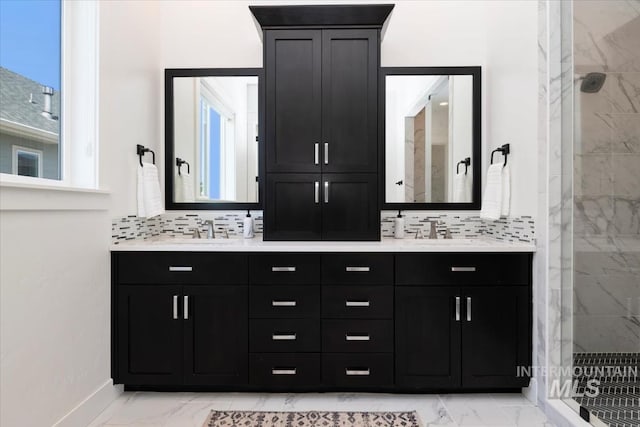 bathroom featuring a shower stall, marble finish floor, and a sink