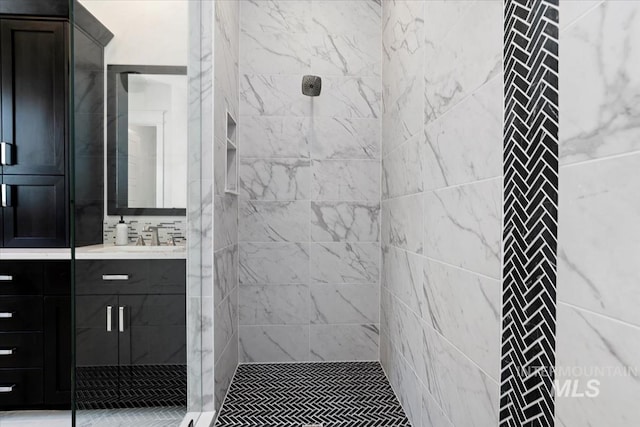 full bath with a shower stall and vanity