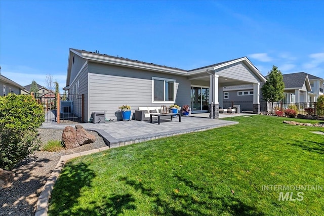 rear view of house featuring a patio area, a yard, fence, and an outdoor hangout area