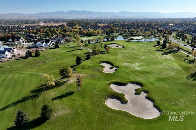 birds eye view of property featuring a water and mountain view, a residential view, and view of golf course