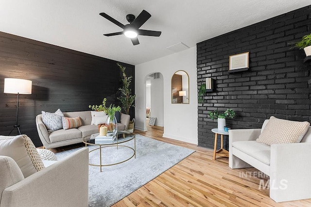 living room with ceiling fan and wood-type flooring