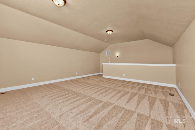855 N Morley Green Pl, Eagle, ID 83616 - additional living space featuring baseboards, carpet, lofted ceiling, and visible vents