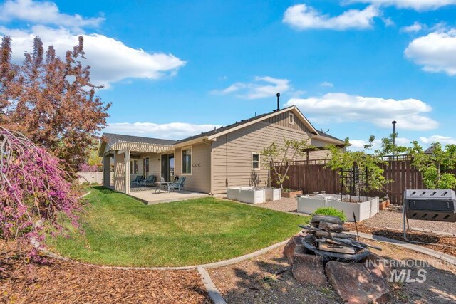 855 N Morley Green Pl, Eagle, ID 83616 - back of property with a patio, fence, a yard, and a vegetable garden