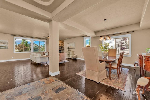 855 N Morley Green Pl, Eagle, ID 83616 - dining area featuring baseboards, dark wood-style flooring, and ceiling fan with notable chandelier