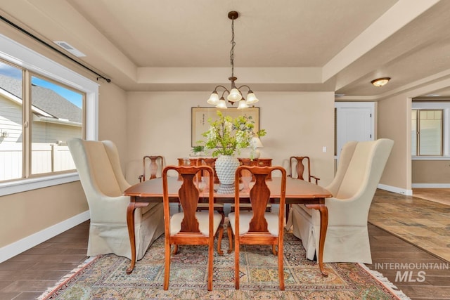 855 N Morley Green Pl, Eagle, ID 83616 - dining space featuring a raised ceiling, baseboards, wood finished floors, and a chandelier