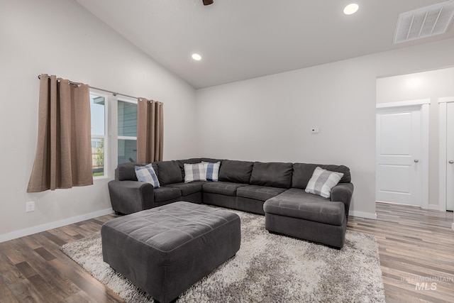 living room featuring hardwood / wood-style floors and high vaulted ceiling