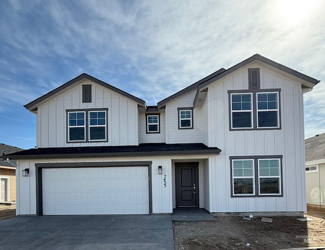 view of front facade with concrete driveway, board and batten siding, and an attached garage