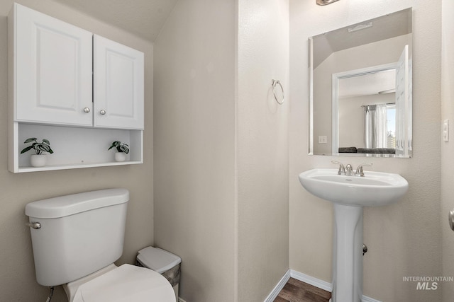 868 S Wiston Pl, Kuna, ID 83634 - half bath with toilet, wood finished floors, baseboards, and a sink