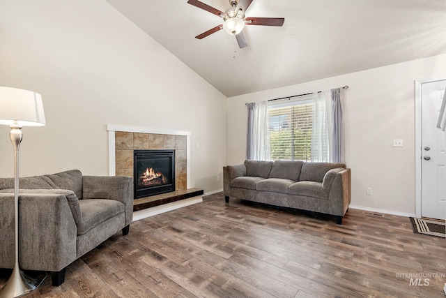 868 S Wiston Pl, Kuna, ID 83634 - living room with wood finished floors, ceiling fan, a tile fireplace, high vaulted ceiling, and baseboards