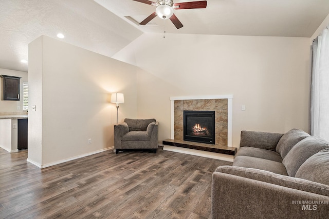 868 S Wiston Pl, Kuna, ID 83634 - living area with ceiling fan, dark wood-style flooring, a tile fireplace, lofted ceiling, and baseboards