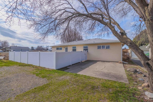 back of house with a patio and fence