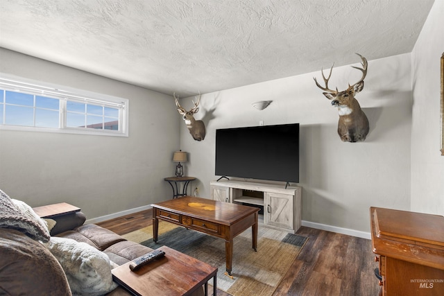 living area with a textured ceiling, wood finished floors, and baseboards