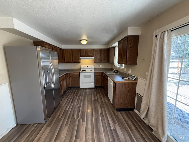 10342 W Ardyce St, Boise, ID 83704 - kitchen with white appliances, dark wood-style flooring, a sink, under cabinet range hood, and a textured ceiling