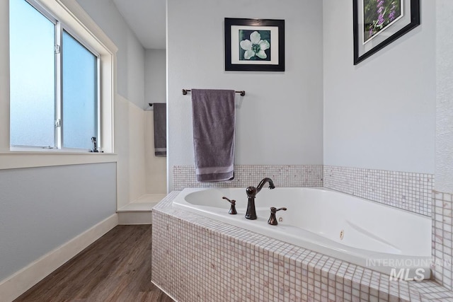 bathroom featuring wood-type flooring and separate shower and tub