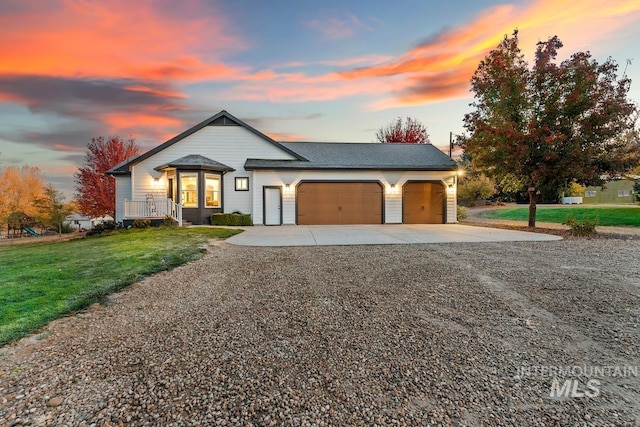 view of front of house featuring a garage and a lawn