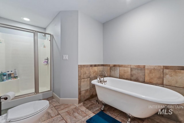 bathroom featuring shower with separate bathtub and toilet