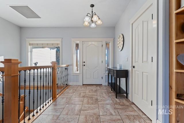 foyer entrance with a chandelier