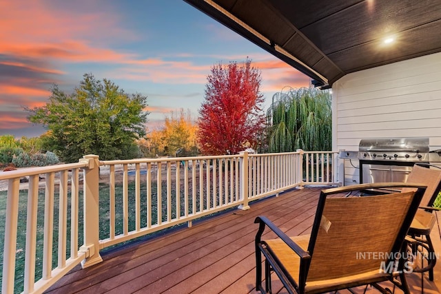 deck at dusk with a grill