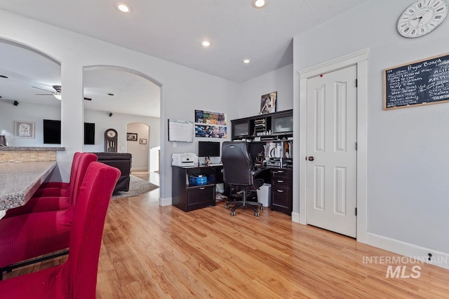 office area with ceiling fan and light hardwood / wood-style flooring