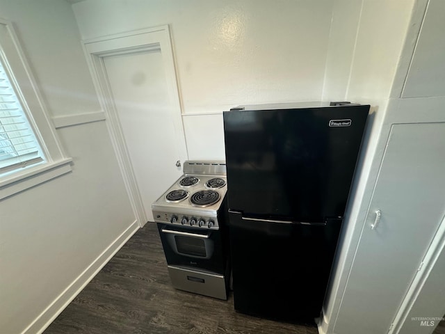 kitchen with stainless steel electric stove, dark hardwood / wood-style floors, and black refrigerator